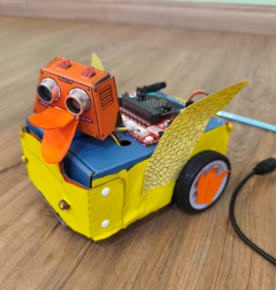 A colorful wheeled robot designed as a duck